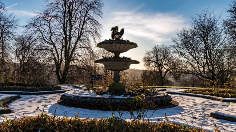 The fountain in the parterre garden in winter at Hughenden, Buckinghamshire